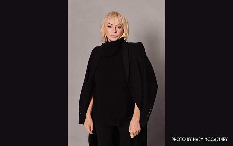 Judy Craymer portrait wearing black outfit. 